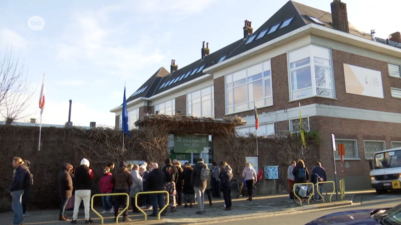 De eerste rij kampeerders is net weg aan deze basisschool, en daar is het volgende tentje al: "Woensdag kind inschrijven in lagere school"